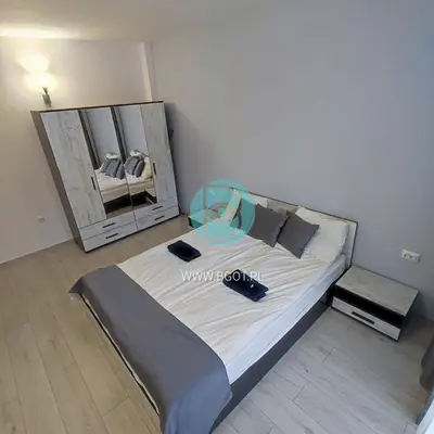 a bedroom with a large bed with a mirror at AVALON premium apartments in Sunny Beach