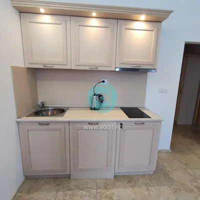 a kitchen with white cabinets and a sink at AVALON premium apartments in Sunny Beach