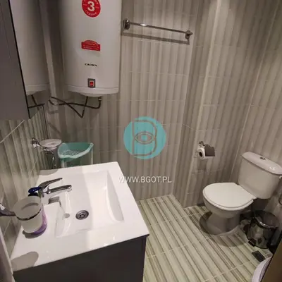 a bathroom with a white sink and a toilet at AVALON premium apartments in Sunny Beach