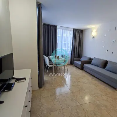 a living room with a couch and a table at AVALON premium apartments in Sunny Beach