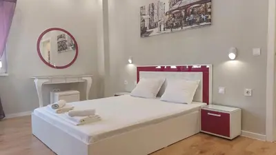 a bedroom with a large white bed with a mirror at Апартамент Pink & Blue - 2BDR with Balcony - Wi-Fi in Varna City