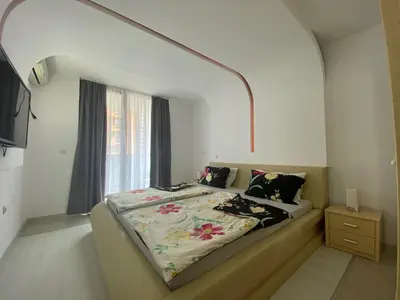 a bedroom with a bed with a large window at VILLA ITTA 05 Apartment Sunny Beach in Sunny Beach