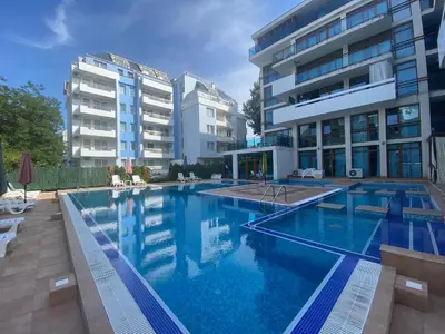 a large swimming pool in front of two buildings at VILLA ITTA 05 Apartment Sunny Beach in Sunny Beach