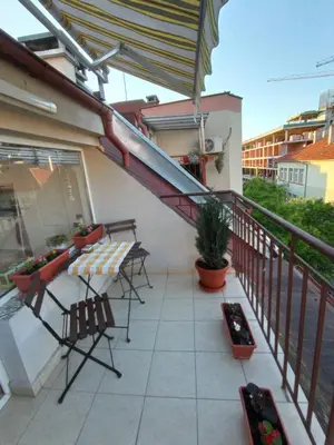 a balcony with a table and chairs and a staircase at Studio San Stefano in Burgas City