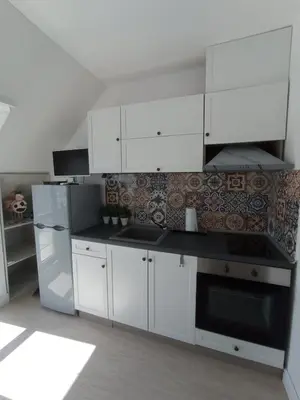 a kitchen with white cabinets and a stove top oven at Studio San Stefano in Burgas City