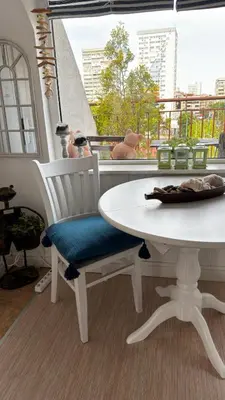 a white table and chair with a table and a window at Studio San Stefano in Burgas City