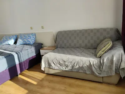 a bed and a couch in a room at Silver Beach B16 in Byala