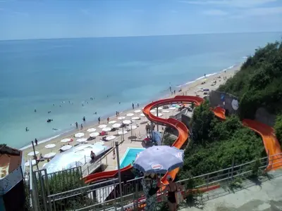 a water slide on a beach with people on the beach at Silver Beach B16 in Byala