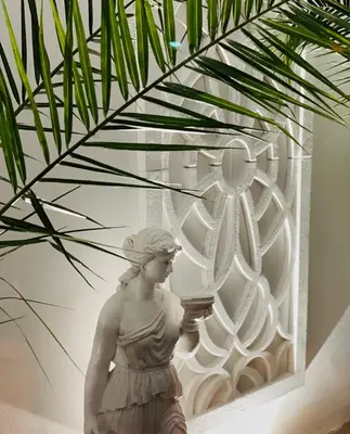 a statue of a woman standing next to a wall at Hotel AVENUE in Ravda