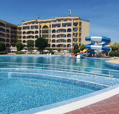 a swimming pool with a water slide in front of a hotel at Студио Релакс, Ахелой in Aheloy