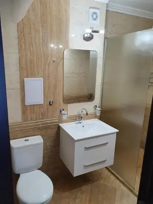 a bathroom with a toilet and a sink and a mirror at Апартамент За Гости ,,1В-15