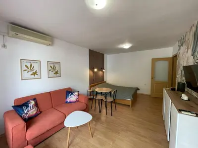 a living room with a couch and a table at Messambria Fort Beach - Premium Apartments in Elenite