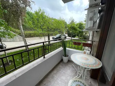a balcony with a table and a potted plant at Messambria Fort Beach - Premium Apartments in Elenite