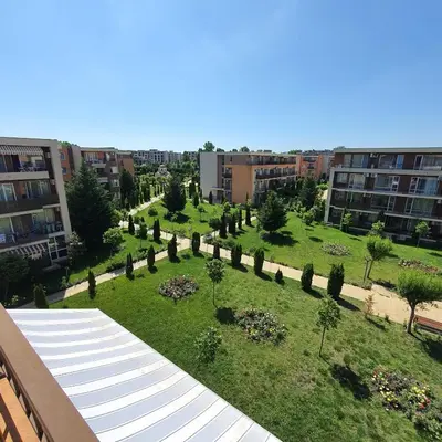 a view of a park with trees and buildings at Holiday Fort Golf Club - Premium Apartments in Sunny Beach