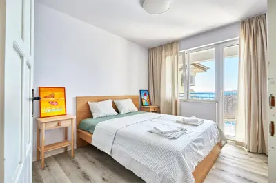 a bedroom with a bed and a large window at 1BD Flat with a stunning SEA VIEW in Sozopol by Flаt Manаger in Sozopol