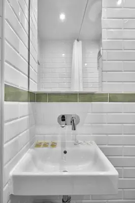 a white bathroom with a sink and a towel at 1BD Flat with a stunning SEA VIEW in Sozopol by Flаt Manаger in Sozopol