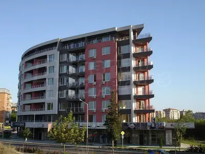 a tall red building with trees in front of it at Апартамент за гости Соня Guest Apartment Sonya in Nesebar