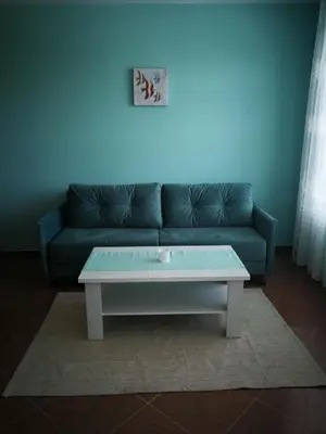 a living room with a couch and a coffee table at Апартамент за гости Соня Guest Apartment Sonya in Nesebar