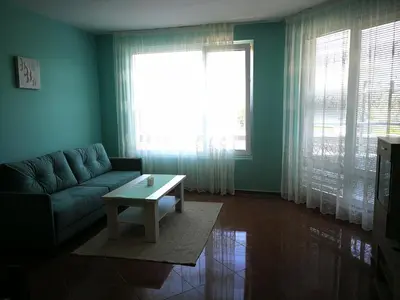 a living room with a couch and a coffee table at Апартамент за гости Соня Guest Apartment Sonya in Nesebar