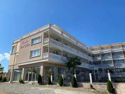 a large building with balconies on the side of it at Студио Симона 3 - първа линия море in Lozenets