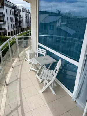 a patio with two chairs and a table on a balcony at Day Dream in Burgas City