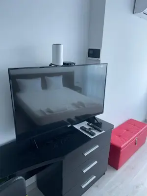 a large flat screen tv sitting on a dresser at Day Dream in Burgas City