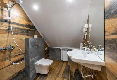 a bathroom with a sink and a toilet and a shower at Хотел Камъните in Burgas City