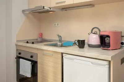 a kitchen with a sink and a pink appliance at Sunny apartment in a complex with a POOL and GYM by Flаt Manаger in Sunny Beach