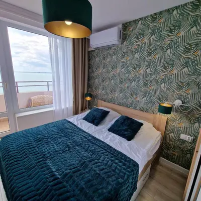 a bedroom with a bed and a large window at PANORAMA MARINA FORT BEACH & GRAND RESORT - Premium Apartments Sea Viev in Sveti Vlas