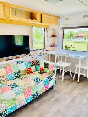 a living room with a couch and a table at Caravans 10 min to Tsonevo Lake & 35 min to Black Sea in Tsonevo