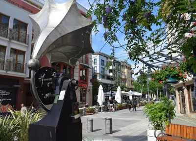 a statue in the middle of a city street at Top center apartment Gramophone with private parking in Burgas City