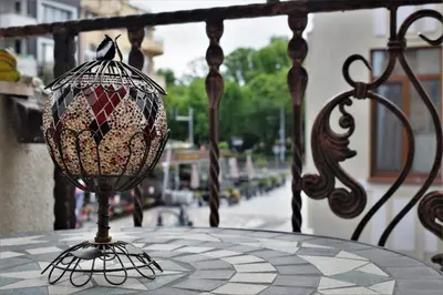 a glass vase sitting on a table on a balcony at Top center apartment Gramophone with private parking in Burgas City
