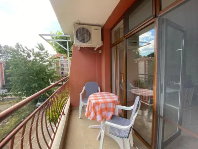 a balcony with two chairs and a table on it at ANITA A15 Family Apartment Sunny Beach in Sunny Beach