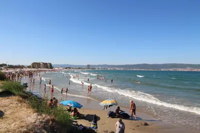 a group of people on a beach with the ocean at ANITA A15 Family Apartment Sunny Beach in Sunny Beach
