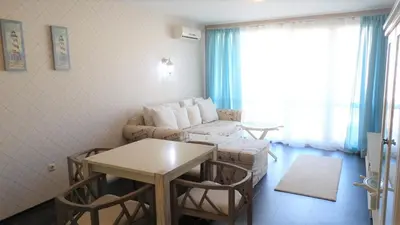 a living room with a couch and a table at Captain's Island Deluxe in Chernomorets