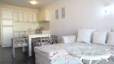 a living room with a couch and a table at Captain's Island Deluxe in Chernomorets