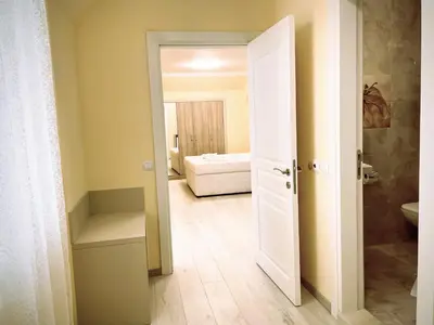 an open door to a bathroom with a bedroom at Private apartments Stamopolu lux in Primorsko