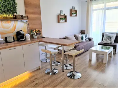 a living room with a table and a couch at Little Treasure by the Sea in Pomorie