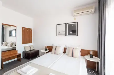 a hotel room with a bed and a chair at Sea House Afrodita II in Nesebar