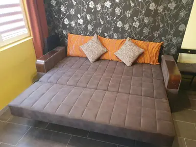 a bed in the corner of a room at Eli Apartment Burgas Center in Burgas City