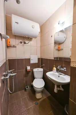 a bathroom with a toilet and a sink at Eli Apartment Burgas Center in Burgas City