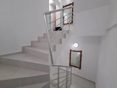a staircase with a metal railing and a mirror at Guest Rooms Kostovi in Nesebar