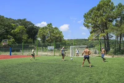 a group of men playing soccer on a field at Hotel Forest Beach in Primorsko