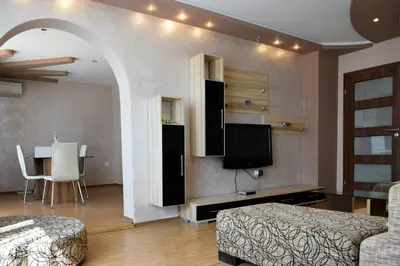 a living room with a bed and a tv and a table at dream apartment in Obzor