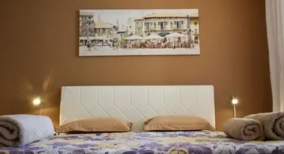 a bedroom with a bed and a painting on the wall at dream apartment in Obzor