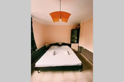a bedroom with a bed in a small room at Cute Little House with a White Picket Fence in Burgas City