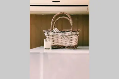 a basket sitting on a counter with a candle at Cute Little House with a White Picket Fence in Burgas City