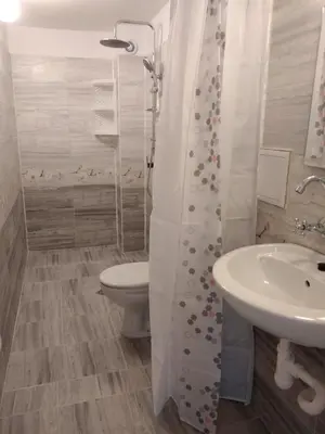 a bathroom with a toilet and a sink at Къща за гости Синьо Лято in Pomorie