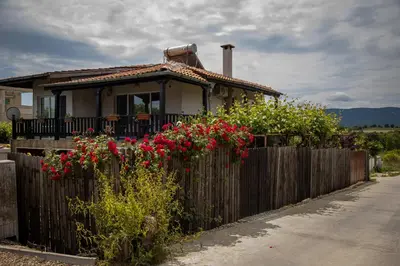 a house with a fence and flowers in front of it at Villa Beni - 4 Bedroom Private House by Flаt Manаger in Lozenets