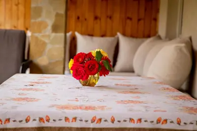 a vase of red and yellow flowers sitting on a table at Villa Beni - 4 Bedroom Private House by Flаt Manаger in Lozenets